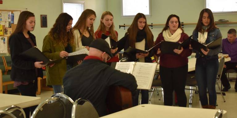 The Florida School District's Seward Select Choir, under the direction of Mark Visconti (seated with back to the camera), entertained attendees at the Friendly Visitor Program Volunteer/Appreciation Holiday Party on Dec. 11. Members of the Golden Hill Band also entertained the group.