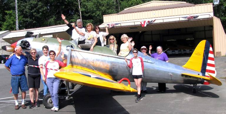 Ninety Nines touch down at Warwick airpor Photo by Roger Gavan Members of the North Jersey chapter of the ìNinety Nines,î an international organization of women pilots, pose by a PT 22, a World War II U.S. Army primary pilot trainer, with Warwick Municipal Airport Manager Dave MacMillan.