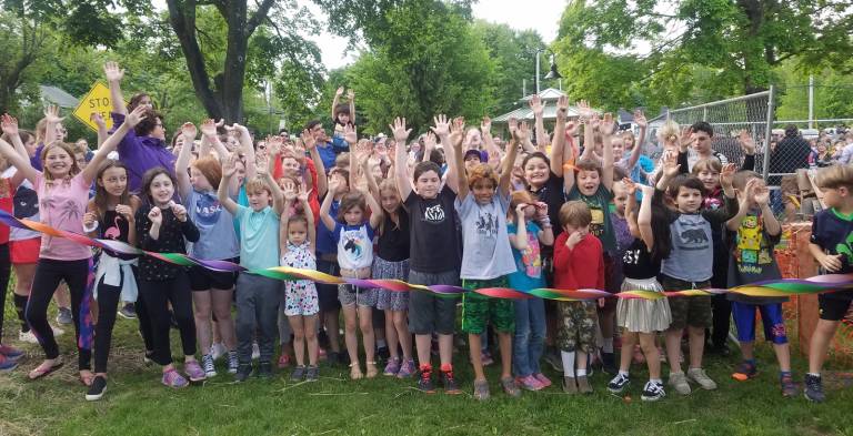 Photo by Taylor Sterling A large group of children were eager to crash through the ribbon.