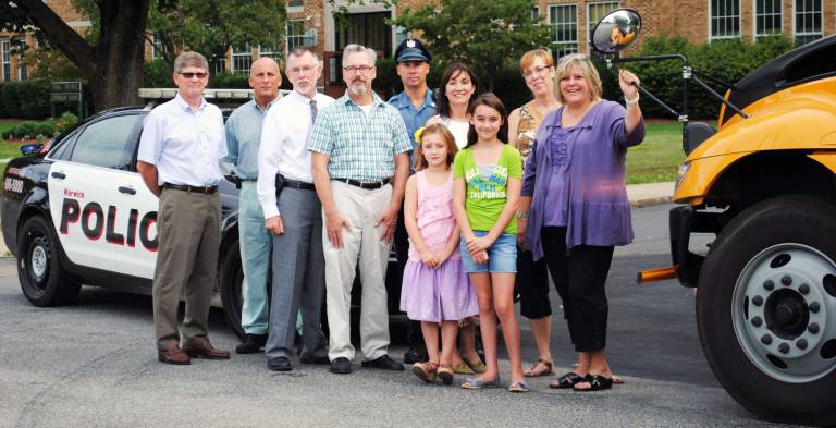 Officials urge caution urge caution with school opening next week Photo provided by the Warwick Valley School District Reminder: Schools open, drive safely: Pictured from left to right are Warwick Valley School Board President David Eaton; WVCSD Director of Human Resources and Safety John B. Russo; Warwick Town Supervisor Michael Sweeton; Mayor Michael Newhard; Police Officer Kevin Terry; Park Avenue PTA Co-President Jeanine Wadeson; students Annabelle and Madeleine Wadeson; WVCSD Supervisor of Transportation Debra Weissman; and Park Avenue School Principal Johnna Maraia.