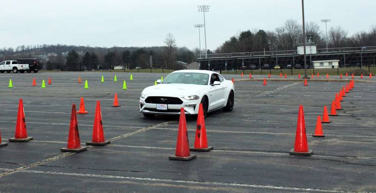 Ford’s innovative suits aim to put the brakes on impaired driving Athletic Director Greg Sirico drives a Ford Mustang provided by Leo Kaytes Ford while in the Ford's Drugged Driving Suit on a test track set up at Warwick Valley High School.
