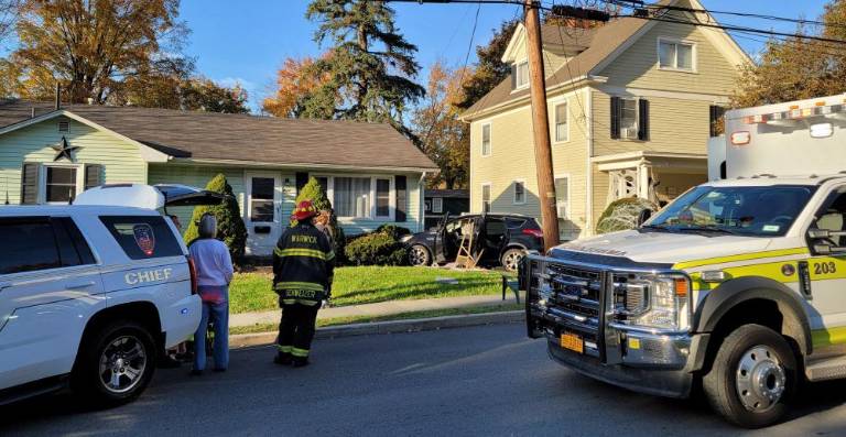 The car stopped at the corner of a neighboring house.