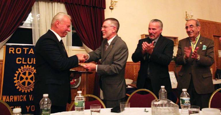 John Woloszczak feted as Citizen of the Year Photo By Mike Woloszczak John Woloszczak Jr. accepts congrulatuions from Michael Sweeeton, master of ceremonies, Rotary President John Buckley and Leo Kaytes, co-chair of the event, at the banquet honoring him as Warwickís Citizen of the Year for 2012-13.