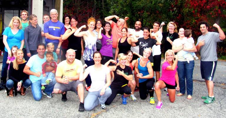 CrossFit Warwick to participate in Pink Friday on Oct. 19 Photo by Roger Gavan CrossFit co-owners Ryan and Katie Hansen (center) often enlist their students in community service such as Pink Friday.