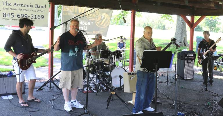 Photos by Roger Gavan Tom Lovelace (second from left), who hosts a Saturday music program on WTBQ and who also arranged for the bands like New York Retro Rocker pictured here, welcomed the guests and reminded everyone that this was a celebration of three 50th anniversaries: The Warwick Valley Humane Society&#x2019;s animal shelter, Radio WTBQ and the famous 1969 Woodstock music festival.