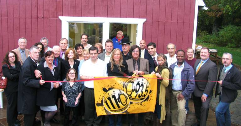 WTBQ hosts grand opening for new studio in Warwick Photo by Roger Gavan On Sept. 28, WTBQ Sales and Marketing Director Souzie Miller and WTBQ Radio owner Frank Truatt (center), surrounded by federal, state and local officials, WTBQ personnel, members of the Warwick Valley Chamber of Commerce, advertisers and other guests, cut the ribbon outside the stationís new studio facility on Sanfordville Road.