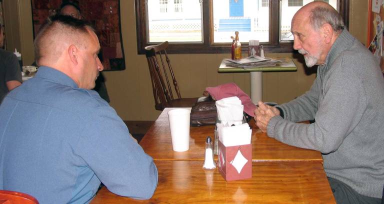 Another round of coffee and cops Greenwood Lake resident Richard Piazza, right, was interested in general police duties and practices and asked Warwick Police Lt. John Rader how they have changed to improve the safety of the community over the years.