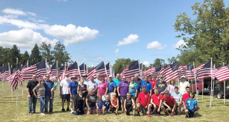 Members of Warwick Valley Rotary erect Flags for Heroes last year. This year’s Flags for Heroes will go up at Chateau Hathorn on Sunday, Aug. 23.