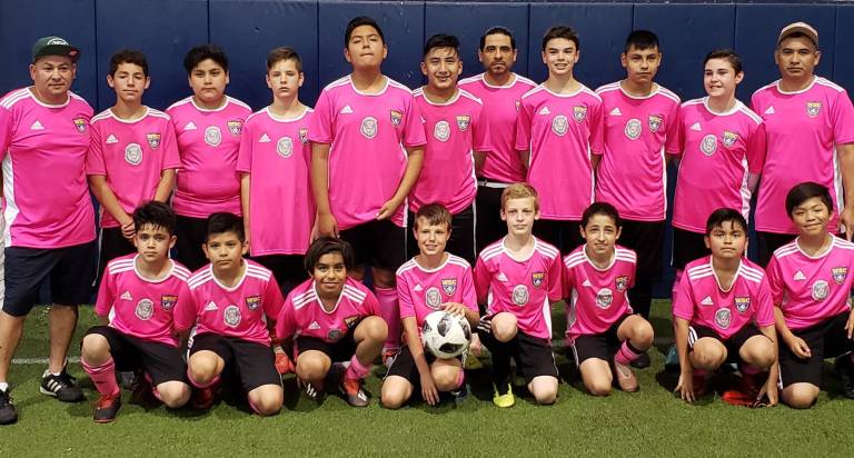 Standing, from left to right,are: Coach Roberto, Carlos, Antonio, Luke, Anthony, David, Coach Ricardo, Ethan, Julio, Joshua and Coach Carmelo; and in front: Santiago, Jesse, Giovanni, Ryan, Mackery, Kenai, Omar and Jesus.