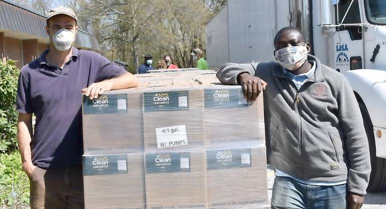 Commercial Horticulture educator and organic grower Erik Schellenberg and Food Safety educator Nathaniel Lartey at the regional distribution in Millbrook.