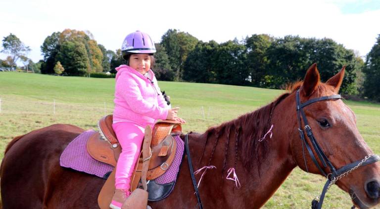 Applefest 2018 draws huge crowds Miley Cabanas, 4, is ready to enjoy a fun ride atop "Daisy," courtesy of Warwick's Winslow Therapeutic Riding Center.