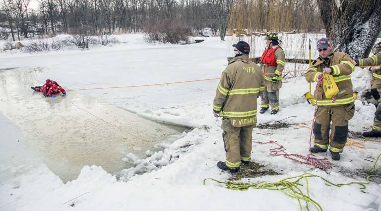 Preparing for when hell freezes over Pine Island First Assistant Fire Chief Peter Vutianitis directs a simulated ice rescue drill as two firefighters are pulled off the ice with ropes on a pond at Pine Island Turf Nursery on Sunday morning, Feb. 23.
