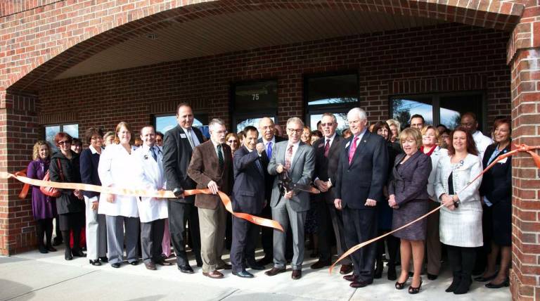 Crystal Run expands in Warwick On Wednesday, Dec. 5, county and local officials along with members of the Orange County and Warwick Valley Chambers of Commerce, representatives of local hospitals and medical organizations and other guests joined Dr. Hal Teitelbaum, managing partner and CEO of Crystal Run Healthcare, and staff members for the grand opening of the organizationís newly expanded offices at 75 Ronald Reagan Boulevard. Pictured in the front center group are, from left: Town of Warwick Supervisor Michael Sweeton, Orange County Executive Ed Diana, Orange County Chamber of Commerce President Dr. John DíAmbrosio, Dr. Hal Teitelbaum (cutting ribbon); and Michael Johndrow, executive director of the Warwick Valley Chamber of Commerce. Photo by Roger Gavan