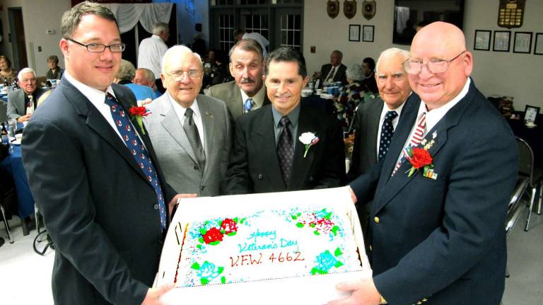 VFW Post 4662 hosts dinner Photo by Ed Bailey Members of VFW Post 4662 hold the cake before cutting at dinner last Saturday evening.