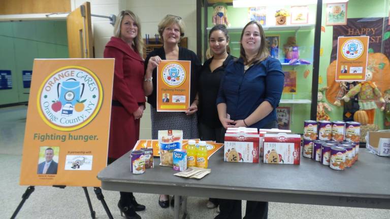 Darcie Miller, Orange County&#x2019;s Commissioner of Social Services, pictured on the far left, was selected a Woman of Achievement for 2017. With her at a backpack-filling event at Chester Elementary School in 2015 are (from left) Cindy Walsh, Chester Elementary School Principal; Josette Ramnani, Hudson Valley Coordinator Food Bank Children&#x2019;s Program; and Betsy Dickson, Regional Food Bank of Northeastern New York (Photo by Frances Ruth Harris)