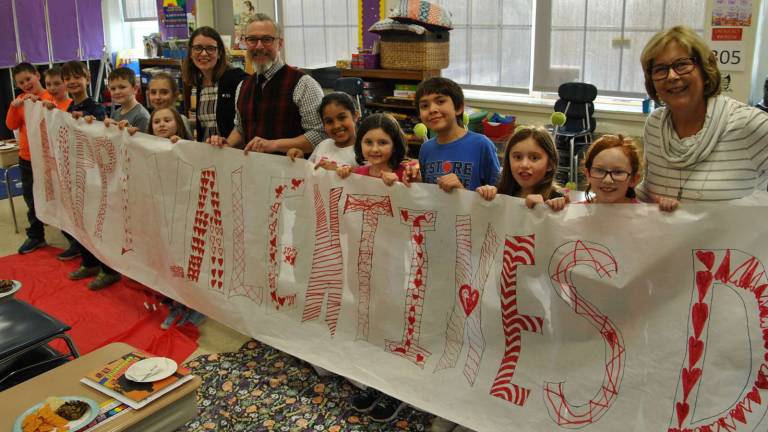 Photo by Louise Hutchison Village of Warwick Mayor Michael Newhard and Sesquicentennial Committee member, Mary Collura, join Park Avenue Student Council members and teacher Sally Woglom as they create decorations for the Valentine&#x2019;s Day dance for local senior citizens on Tuesday, Feb. 14, at Park Avenue Elementary School.