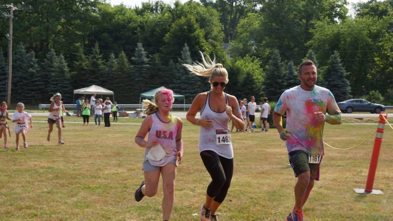YMCA raises over $10K during Color Run to benefit its Strong Kids Campaign Photos provided Kameryn Lyons, left, Ashlee Wilbur and Todd Lyons were among the 178 5K runners to be doused in color.