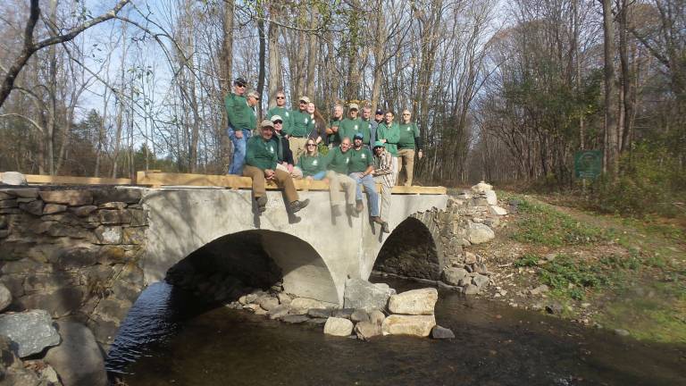 Check out the latest Goosepond trail at park celebration The volunteer crew from the New York New Jersey Trail Conference, pictured last November, enjoys the view from the newly rebuilt bridge over the Seely Brook in Goosepond State Park (Photo by Frances Ruth Harris)