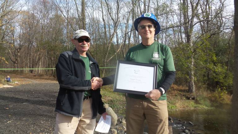 Rotten, broken, dangerous Goosepond bridge is repaired David Booth presented Robert Fuller with the Presidential Volunteer Service Lifetime Achievement Award (Photo by Frances Ruth Harris)