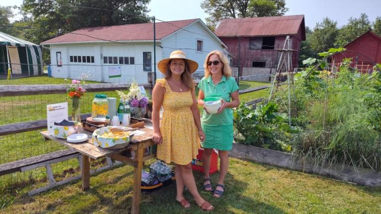 Backyard gardeners open their gates for Kitchen Garden Tour Ambassadors from Wallisch Homestead Community Garden greet garden peepers.