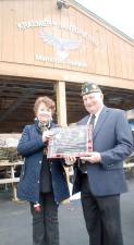 American Legion Post 1443 Commander Tom Mulcahy presented a commemorative plaque to Anita Santopietro, whose husband Peter Santopietro who made many contributions to the Port during his lifetime.