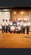 Chris DiMarco, with dark shirt in the middle received the Orange County Medical Services 2021 Basic Life Support Provider of the Year Award. It was given to him by Warwick Fire Chief Michael Contaxis, to the right of DiMarco