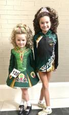 Teagan McNamee and Addison Cohen have fun performing Irish dance together.