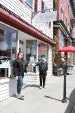 Kally Padilla, owner of Kaliada Boutique, presents a check for $300 to Warwick Ecumenical Food Pantry Director Glenn P. Dickes.