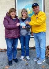 On Nov. 20, the last Saturday before Thanksgiving, Frank Gilbert, the vice president of the Greenwood Lake Lions Club, presented a check in the amount of $2,000 to the Greenwood Lake Food Pantry. Both Pat Nolan and Darcie Barman accepted the check on behalf of the pantry. Pictured with the check, from left to right, are: Darcie Barman, Pat Nolan and Frank Gilbert. Photo provided by Toni Hartig/Greenwood Lake Lions Club.