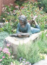 Friends and family of the late Madeline Rose Pillmeier dedicated a bronze statue in her memory on May 15, 2010 at the Florida Public Library. The statue of a young girl reading a book was funded by an outpouring of donations to the library following the fifteen year old Florida student’s death in June 2009. She was an avid reader and a lifelong library user. The statue rests on a rectangular sandstone block with original chisel marks, once a foundation stone in an 18th century barn. According to the library’s web site, the stone was donated by Peter Kimiecik of Kimiecik Landscaping. Tim and Todd Purta, of T.S. Purta Funeral Home, donated the plaque which reads “Once was a girl who loved to read and read – Maddy.” Todd Purta donated his services and that of his crane to transport and install the statue and stone. He was assisted by Ross Folino who also prepared the site.