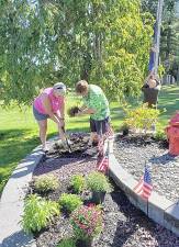 WFD Secretary Deb Schweikart, left, and President Melissa Stevens plant mums at the WFD Monument in Memorial Park. Photos provided by the Warwick Fire Department.