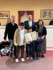 Camila Mamani Escobar celebrates earning her U.S. citizenship with her family at the Warwick Town Board meeting.