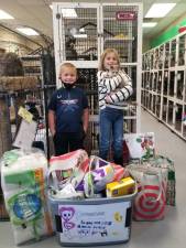 Grace Brown, pictured here with her younger brother Brendan, asked for pet food, medical and cleaning supplies and toys for Warwick Valley Humane Society’s homeless pets in lieu of birthday gifts for herself. Photo provided by the Warwick Valley Humane Society.