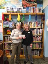 Katherine Callan-Montemaranoof the Greenwood Lake Lions Club presents a $500 donation to Sandy Newman, treasurer of the Greenwood Lake Public Library.