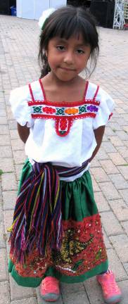 Photos by Roger Gavan Many of the children like Itzayana Tellez, 6, wore colorful costumes.
