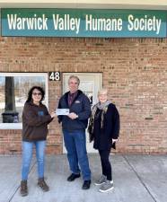 Leo Kaytes and Leslie Culkin hand $2500 check to Suzyn Barron, president of Warwick Valley Humane Society.