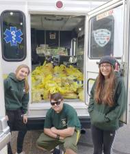 Members of the Warwick Ambulance Junior Corp strike a pose at the ShopRite in Warwick with the food they collected and donated to the Warwick Food Pantry.