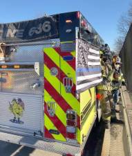 Warwick Firefighter Tim Vreeland and Lt. Robert LoForese hold the thin blue line flag at the escort of deceased Officer Dominic Winum on Intrastate 84 overpass in Slate Hill on Friday. Photos from Warwick Fire Department.