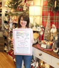 Home for the Holidays co-chair Mary Beth Schlichting with the poster displaying a schedule of events.