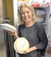 Theresa Mandracchia displays two of the 30 gourmet chicken pot pies donated to the Warwick Ecumenical Food Pantry in honor of Paula Cornine of Warwick with donations provided to Small Things Inc. in her memory. Provided photo.
