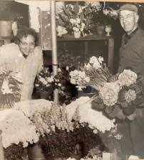 Leah Corwin and Francis Corwin putting together bouquets of their fresh flowers in the 1940s. Photo provided.