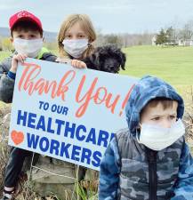 Kimberly Dembeck of Warwick shared this photo of Livia, Ethan and Sawyer Dembeck and their dog Finley making one of the defining and heart-felt statements of this time.