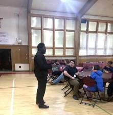Fr. Paul Ajong (Youth Group Chaplain) with some of the children.