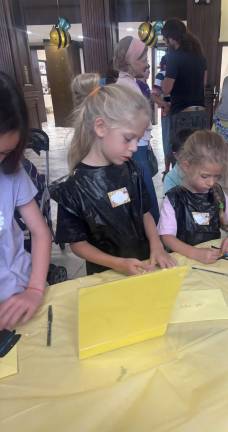 Kids from the community making a honey cake in honor of the upcoming holiday