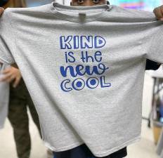 In a library workshop, participants make shirts with personal mantras.
