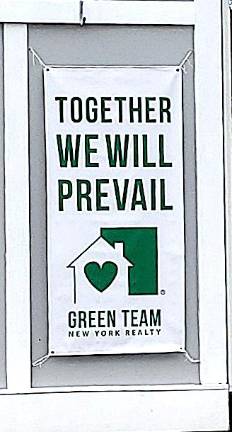 Encouraging sign posted outside the Green Team real estate office in the Village of Warwick. Photo by Roger Gavan.