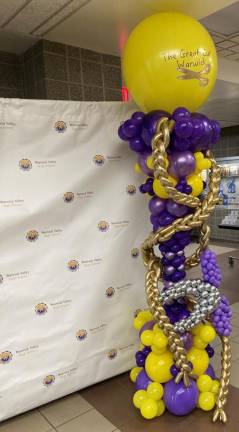 A barber pole made from balloons featuring Warwick school colors.