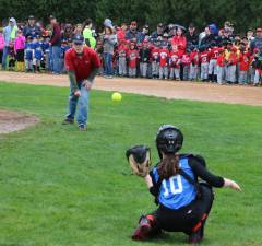 Little League opening day ceremony. Supervisor Sweeton tosses out the first softball to catcher Annie Lincoln.