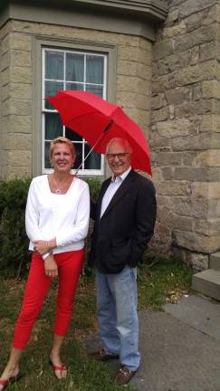 Provided photo Lisa-Ann Weisbrod, the executive director of the Warwick Historical Society, stands with Trustee Michael Bertolini, the man with the red umbrella. He will make his appearance on the streets of Warwick once again on Mother's Day, Sunday, May 14, at 2 p.m., to showcase the history the village has to offer.