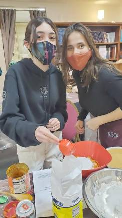 CTeen members Ari Eisner and Hailey Resti, both of Monroe, work together to make a pumpkin pie to help community members in need at Chabad of Orange County’s Center in Chester.